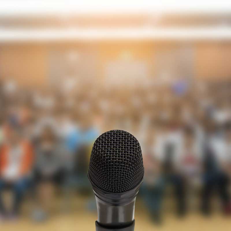 microphone at empty podium in front of crowd
